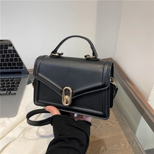 Elegant black minimalist crossbody square bag with gold metal buckle and top handle