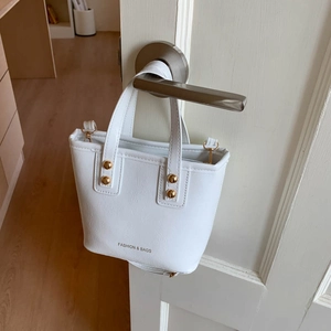White minimalist tote bag with FASHION & BAGS text and gold hardware detail