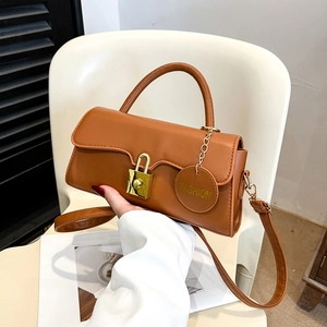 Retro caramel brown leather crossbody bag with golden lock detail and adjustable strap