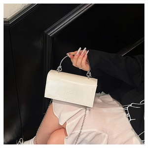 Détail du mini sac blanc avec poignée ronde en métal et logo mim en relief