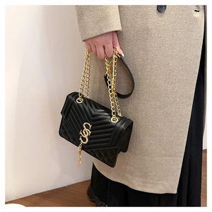 Black chain shoulder bag featuring V-shaped quilting and a gold tassel SSS logo detail