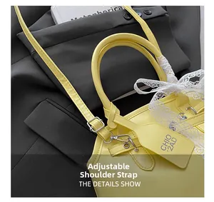 Detail view of yellow crossbody bag featuring a white lace bow and adjustable strap