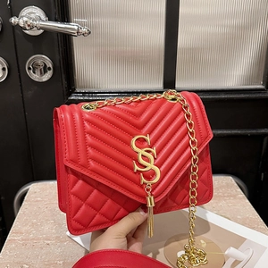 Red quilted chain crossbody bag featuring SSS metal logo and elegant gold tassels
