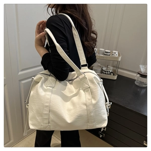 Detailed view of white large capacity PU leather tote bag with reinforced shoulder straps