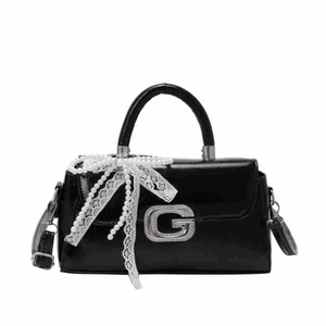 Glossy black patent leather handbag with silver G-buckle, lace bow, and pearl chain strap