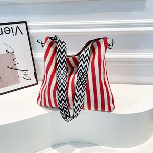 Large red and white striped canvas tote bag with geometric patterned shoulder strap