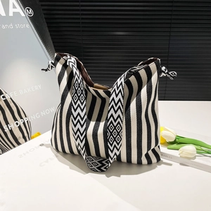 Large striped canvas tote bag with woven geometric shoulder strap for daily shopping