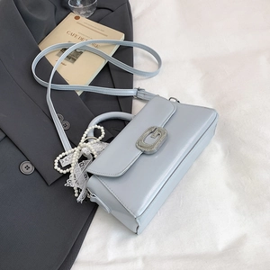 Light blue square handbag detail with silver G buckle and pearl lace ribbon charm