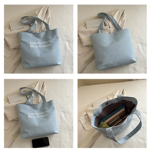 Detail view showing large capacity and internal space of light blue canvas tote bag
