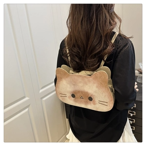 Rear view of a model wearing a cute cat-shaped backpack with brown gradient print and straps