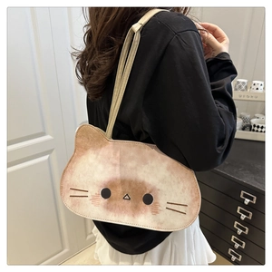 Detailed back view of model wearing the cute watercolor cat bread tote bag with slim straps