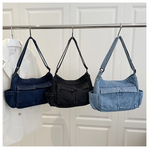 Three denim shoulder bags in blue and black with multi-pocket workwear design details