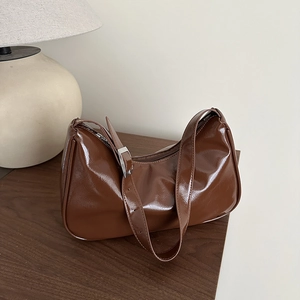 Glossy brown patent leather baguette bag for women with minimalist underarm crescent design
