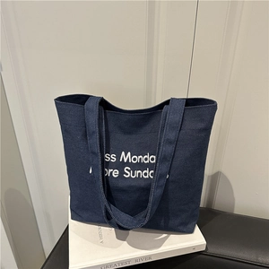 Retro deep blue canvas tote bag with white embroidery and wide shoulder straps