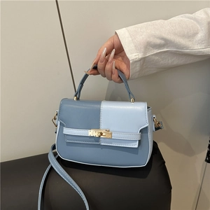 Two-tone blue contrast leather handbag with top handle and gold turn-lock closure