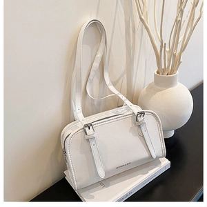 Detail of white rectangular shoulder bag with silver buckles and Fashion & Bag lettering