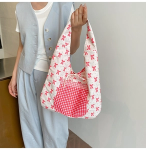 Detail of floral tote bag with red bow pattern and lace-trimmed plaid pocket
