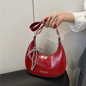 Chic red patent leather half-moon shoulder bag with silver bead bow charm and wide strap