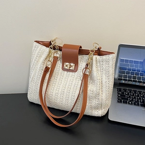 Sac fourre-tout en paille tissé avec poignées en cuir marron et fermoir rotatif doré
