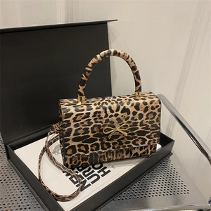 Leopard print handbag with golden bow accent in premium gift box display