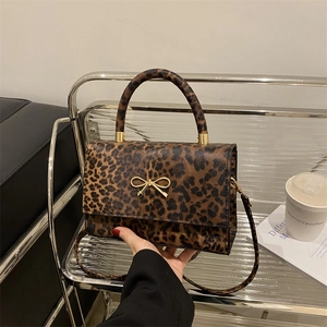 Leopard print crossbody bag with gold bow clasp and detachable shoulder strap