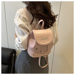 Pink mini backpack detail with IBCMB embroidery and chain on textured leather material