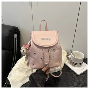 Pink mini backpack detail with IBCMB embroidery, cute patches, and chain decoration