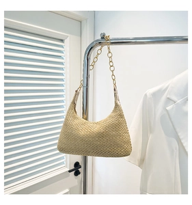 Detail of hand-woven hobo bag with gold metal ring strap and high-quality texture