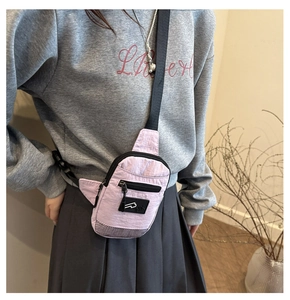 Detail of lavender nylon chest bag featuring front zipper pocket and breathable mesh base