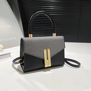 Chic two-tone crossbody bag with black leather, grey fabric, and gold metal hardware