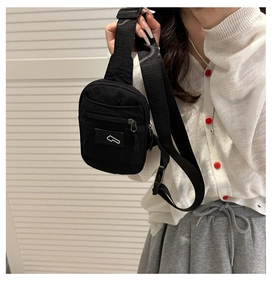 Detail of waterproof nylon chest bag with adjustable strap and minimalist logo label