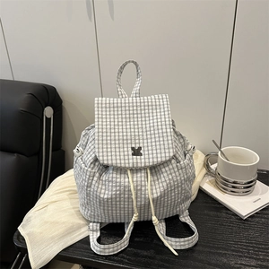 Fashionable black and white checkered drawstring backpack with flap and side pockets