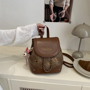 Vintage brown leather and canvas backpack with bear embroidery and plush charm pendant