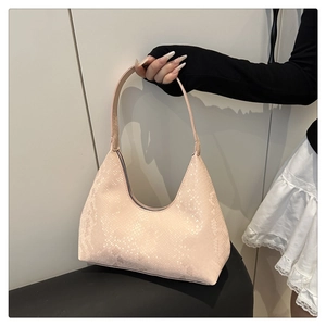 Close-up of pink snakeskin hobo bag texture with smooth zipper and shoulder strap
