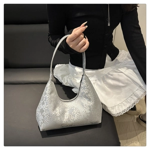 Chic silver snakeskin pattern shoulder bag showcased by a model in a lifestyle setting