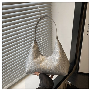 Close-up of silver snake-pattern hobo bag with metallic finish and fashion lettering