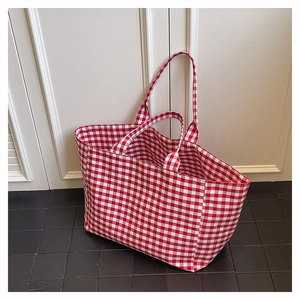 Detailed view of large red and white gingham canvas tote bag with sturdy double handles