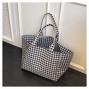 Close-up detail of the black and white gingham canvas fabric and texture on tote bag