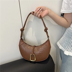 Brown woven half-moon shoulder bag with golden horseshoe buckle and knot detail