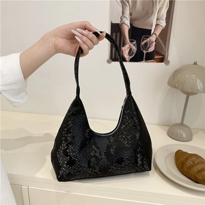 Large black snake-print hobo shoulder bag with a crescent shape and a zipper closure