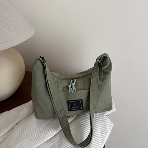 Minimalist olive green nylon crescent crossbody bag with adjustable wide shoulder strap