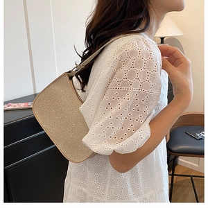 Macro view of champagne gold glitter underarm bag with sparkling metallic texture and strap