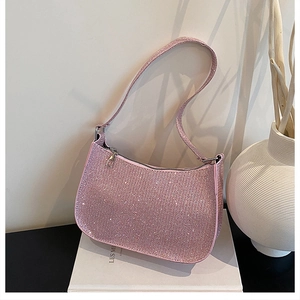 Close-up of a crescent-shaped hobo bag with glittering pink sequins and thin handle