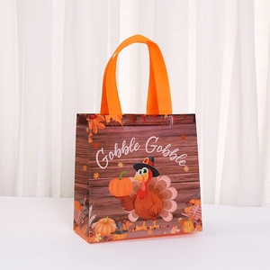 Laminated Thanksgiving turkey gift bag with Gobble Gobble print and orange handles
