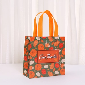 Give Thanks non-woven gift bag with colorful pumpkin prints and orange handles for Thanksgiving