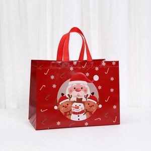 Front view of a red non-woven Christmas gift bag with Santa Claus and reindeer prints
