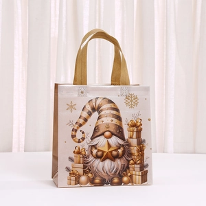 Golden Christmas non-woven gift bag featuring festive gnome and snowflake patterns