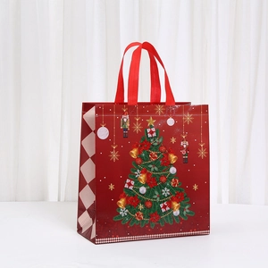 Detail of red Christmas gift bag with nutcracker print and wide carrying handles