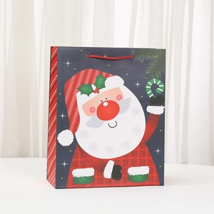 Christmas paper gift bag featuring a cartoon Santa Claus design with red rope handles
