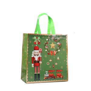 Christmas non-woven gift bag with Nutcracker and festive prints in forest green